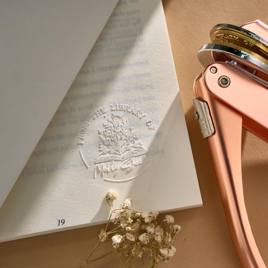 Custom book embosser creating elegant raised impression on book title page