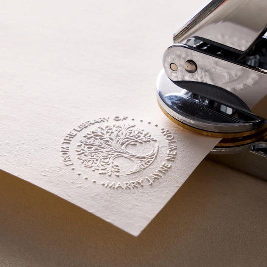 Custom book embosser creating raised impression on title page for personal library